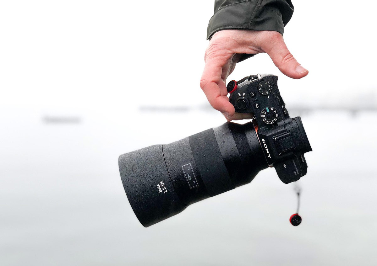 Someone holding a camera with an out-of-focus background.